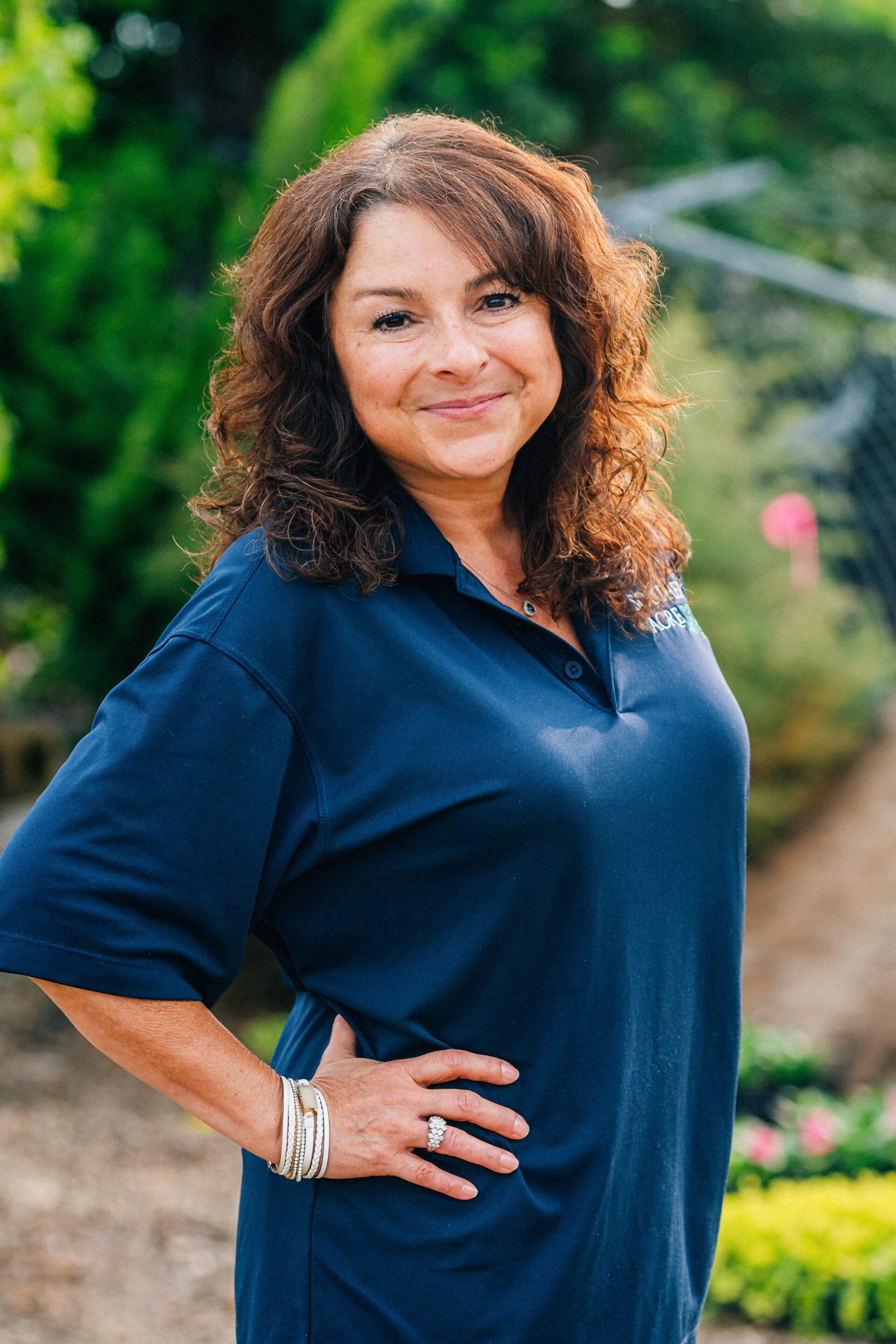 Julie Bogle standing in front of bushes