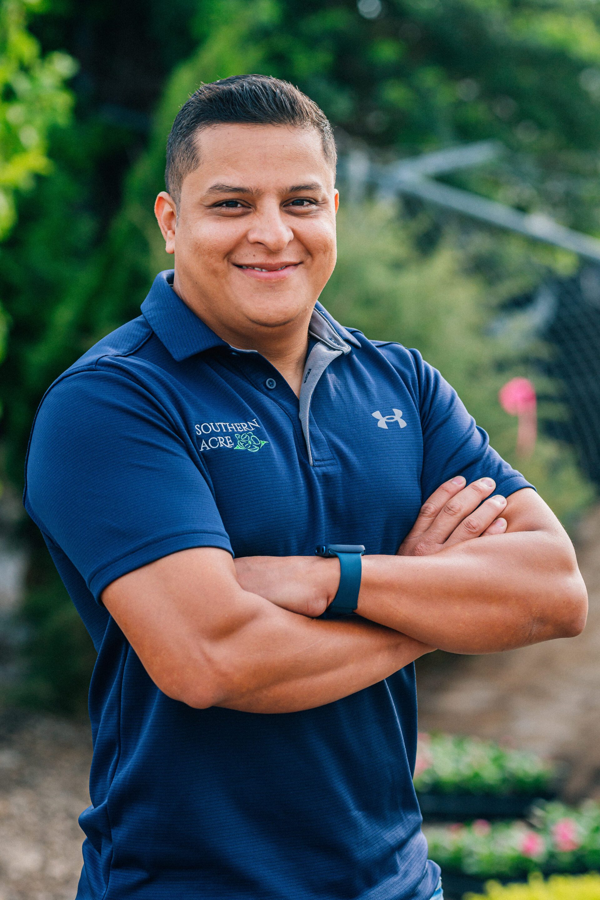 David Flores standing in front of bushes