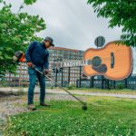 commercial landscape maintenance in front of large nashville sign
