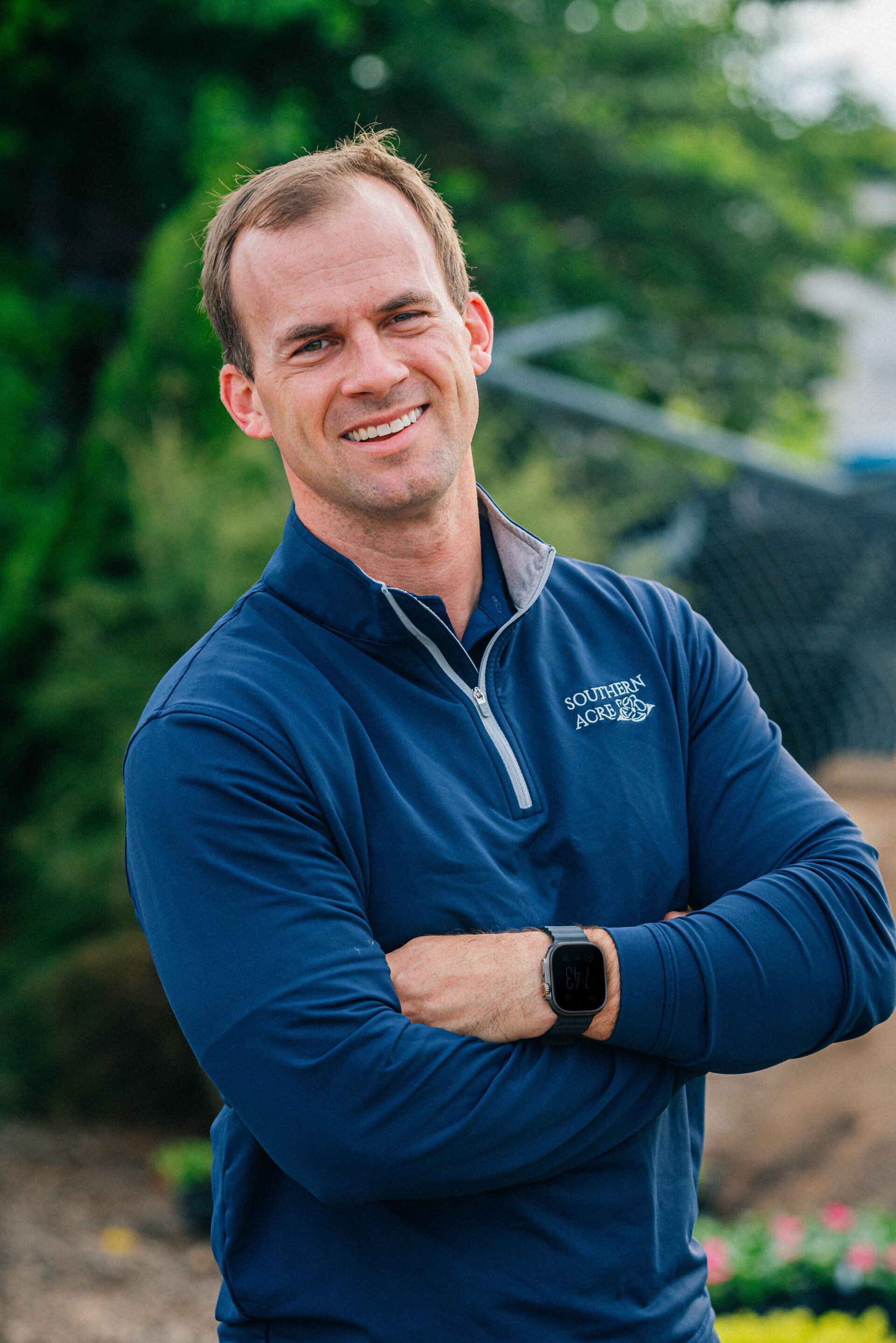 Hall Simmons standing in front of bushes